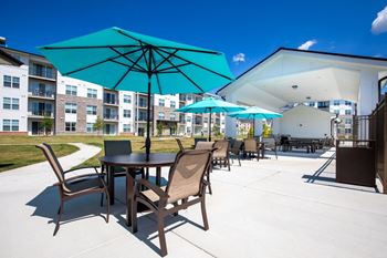 Our apartments have a patio with tables and umbrellas